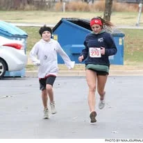 A mother and son running together