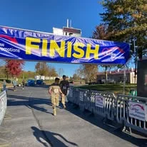 Runners in fatigues nearing the finish line