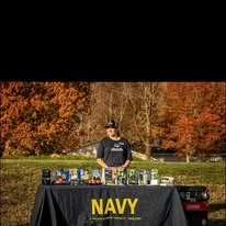 A Navy recruiter at an event booth