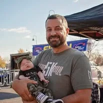 A participant holding a newborn at the event