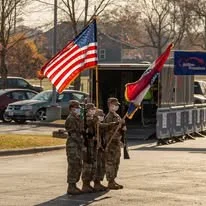 Soldiers carrying flags along the route
